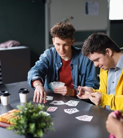 group-of-people-playing-cards-and-board-games-in-c